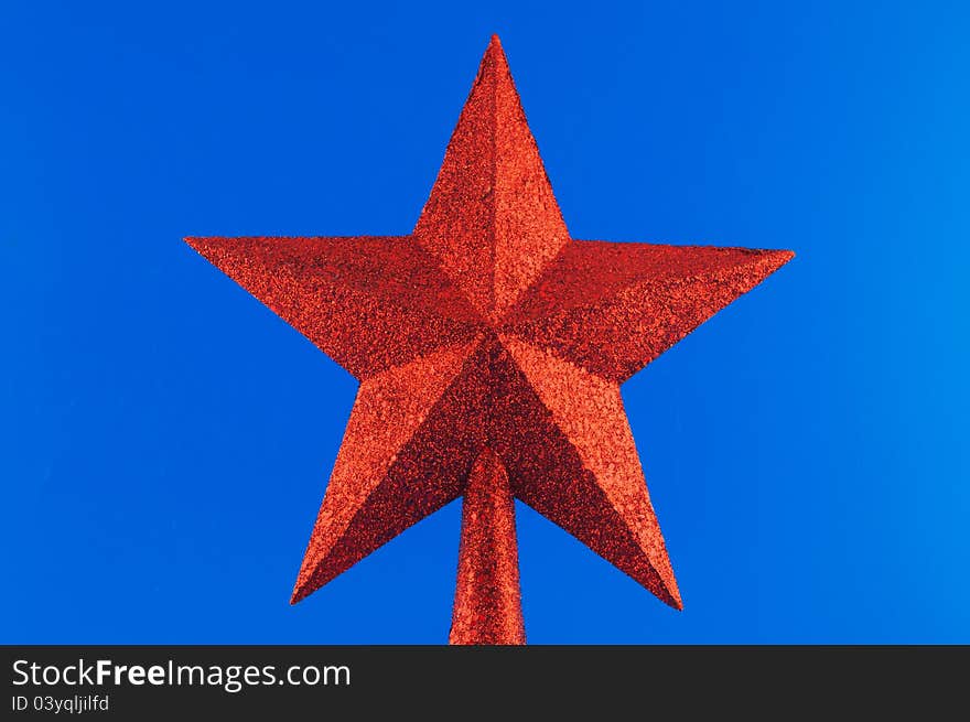 Red five-pointed star toy Christmas tree against a white background. Red five-pointed star toy Christmas tree against a white background