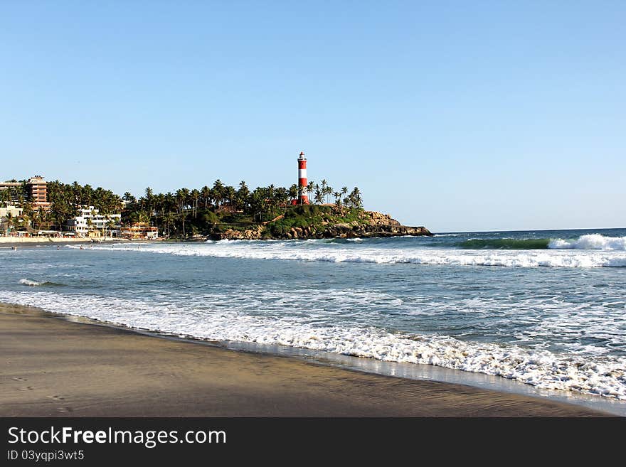 Kovalam international beach on the backdrop of hotels, restaurants and lighthouse