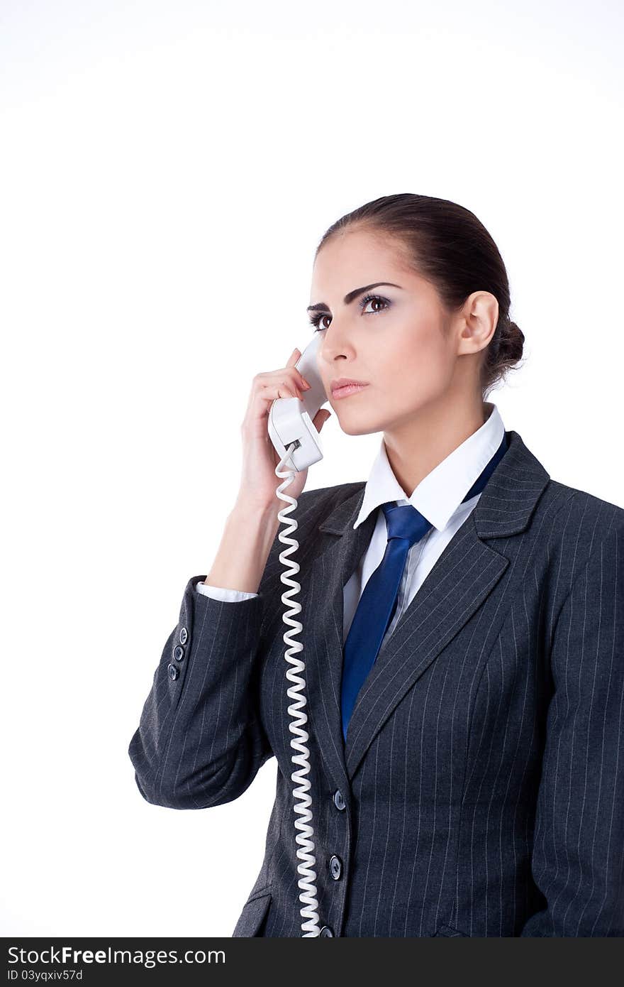 Concentrated businesswoman talking on phone isolates on white