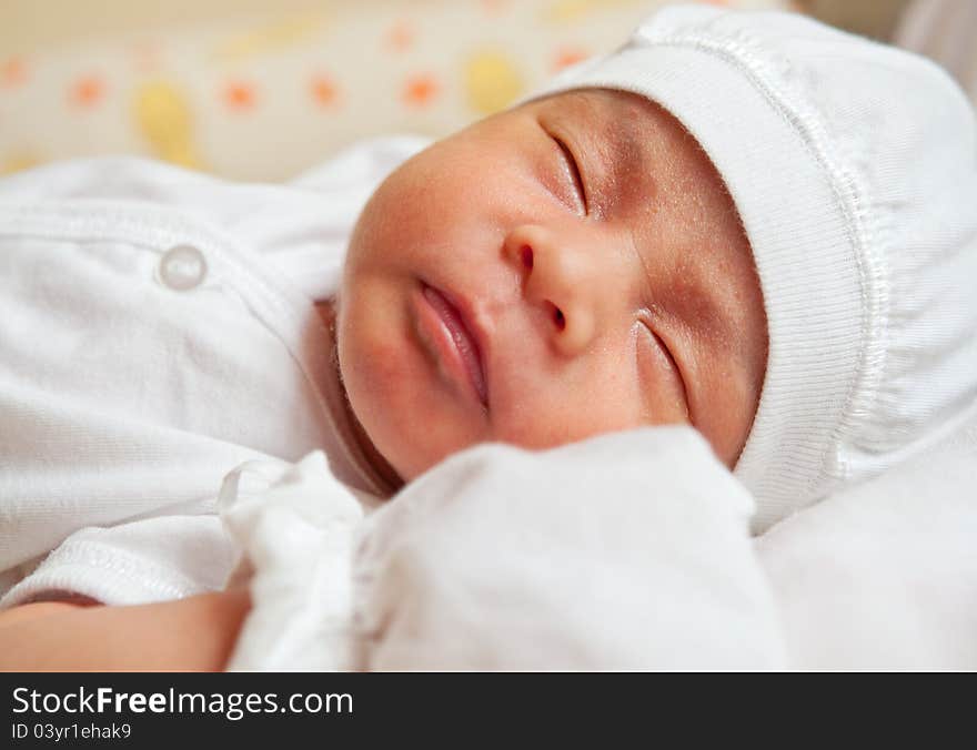 Close up of a newborn child sleeping comfortably. Close up of a newborn child sleeping comfortably.