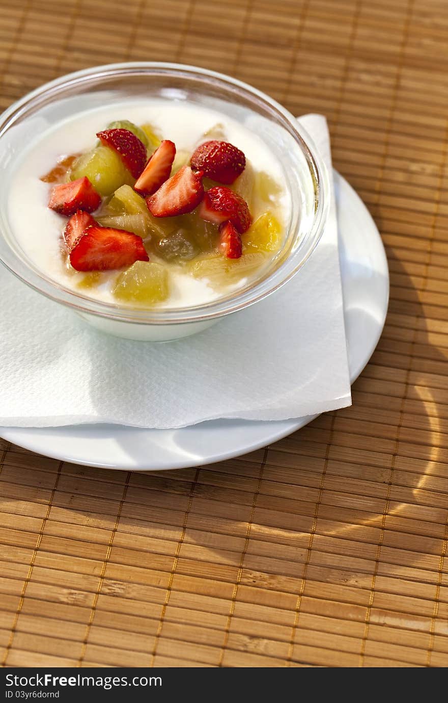 Yogurt with fresh fruits with sunlit lightning effect