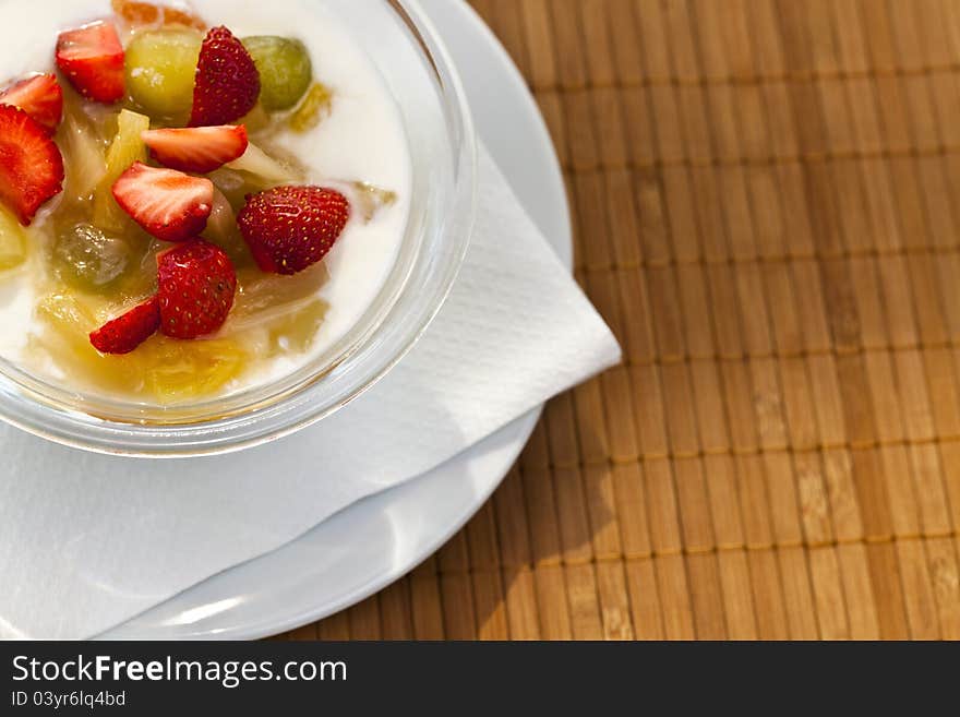 Yogurt with fresh fruits with sunlit lightning effect