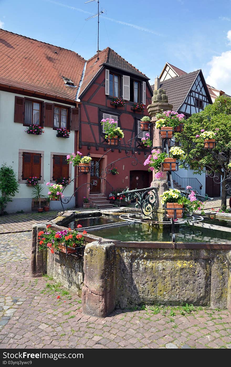 A village square and fountain in alsace on the french german border. A village square and fountain in alsace on the french german border