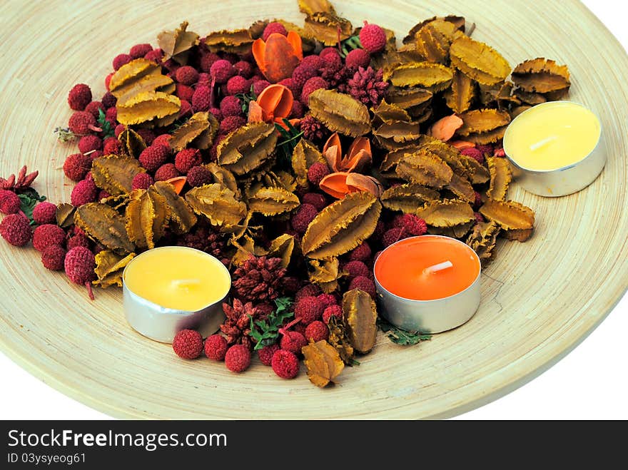 Three candles with dried flowers