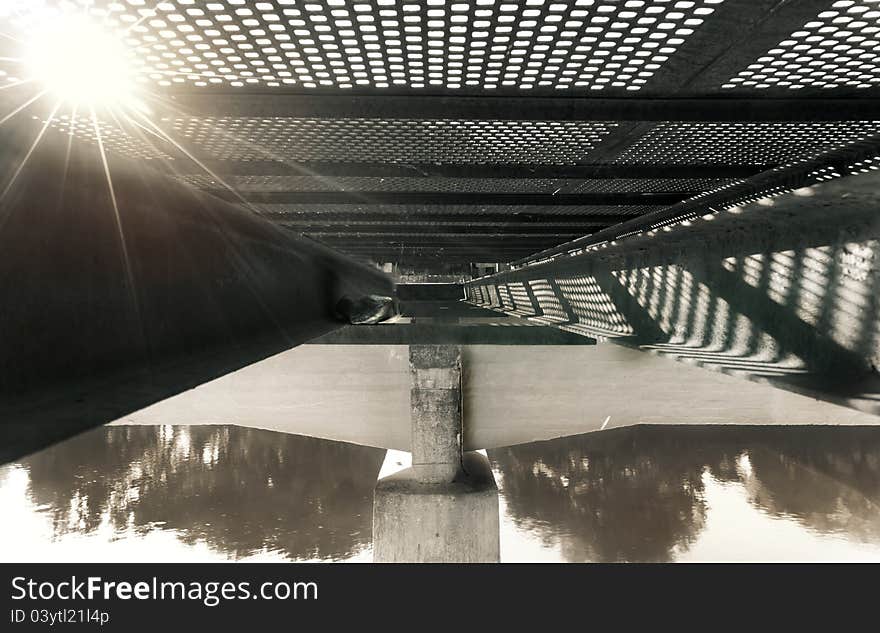 Metal structure of on old metal bridge, from beneath.