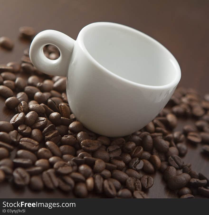 White cup with coffee beans