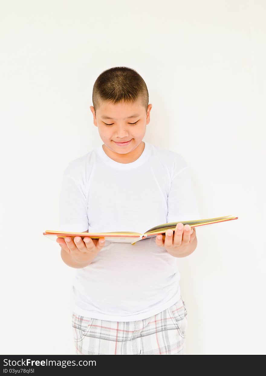 Asian boy reading book on white background