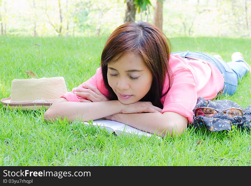 Thai girl sleeping on grass