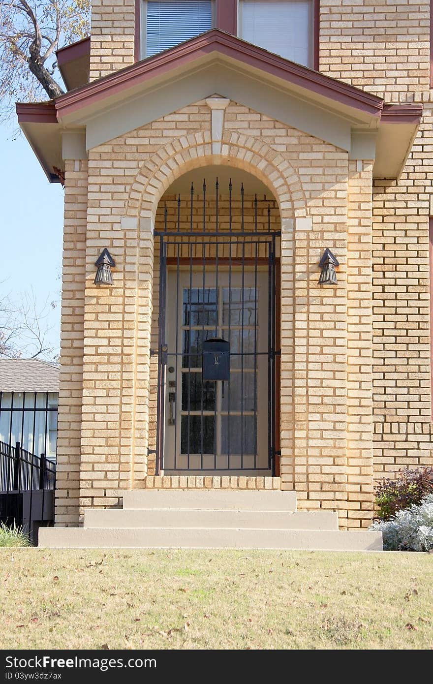 Double door on brick house .iron and wood door.