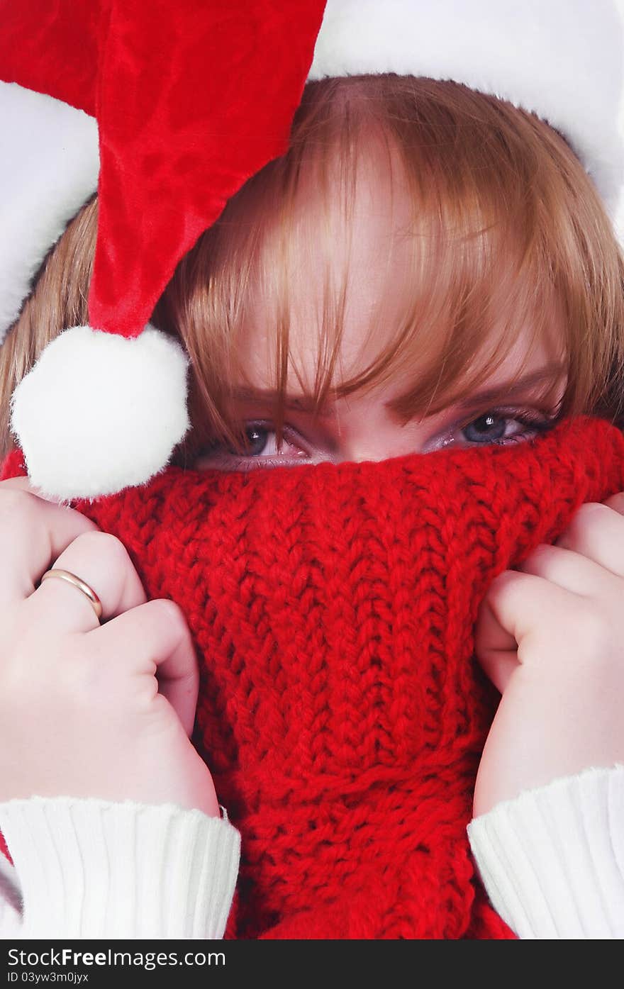 Girl with christmas hat and scarf over white. Girl with christmas hat and scarf over white