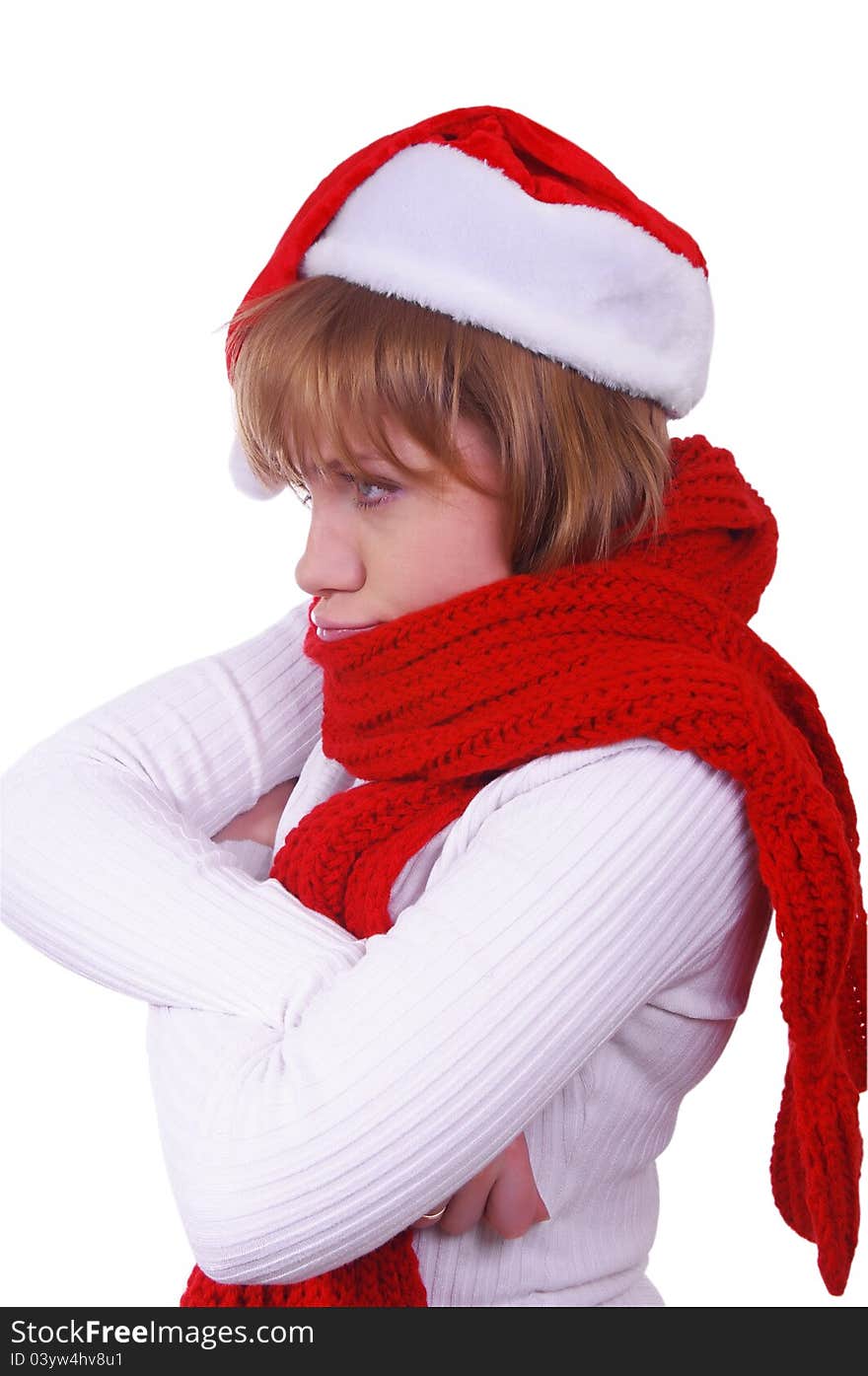 Angry girl with christmas hat and scarf over white. Angry girl with christmas hat and scarf over white