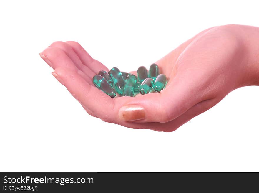 Female hand with medicine pills on white. Female hand with medicine pills on white