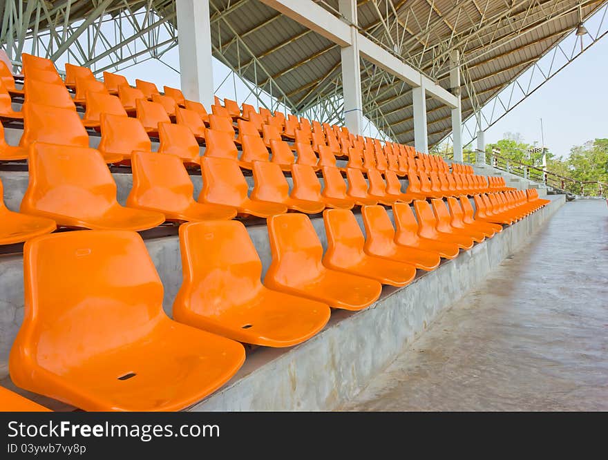 Sheer orange seats arranged in a row. Sheer orange seats arranged in a row.