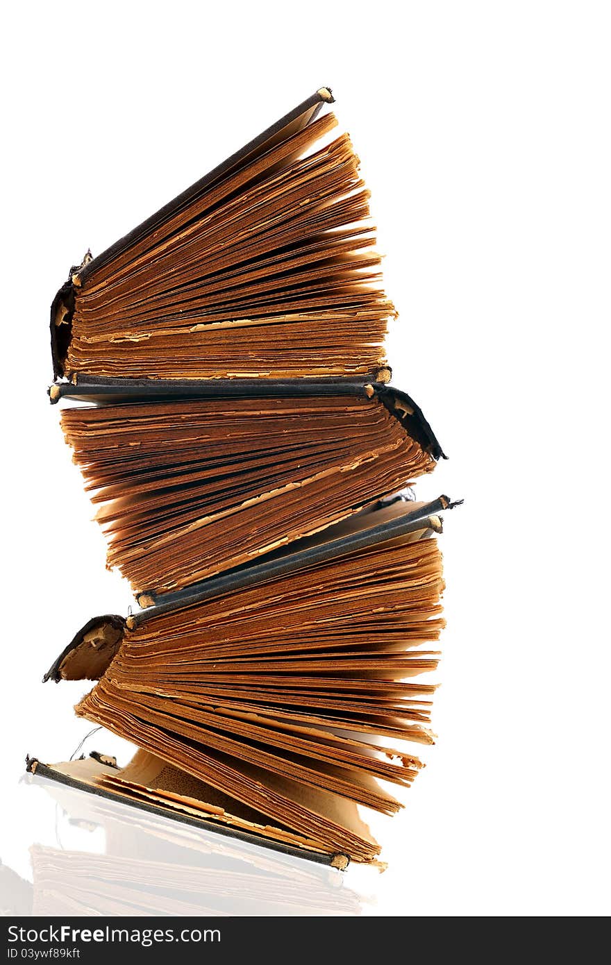 Stack of old damaged books on white background