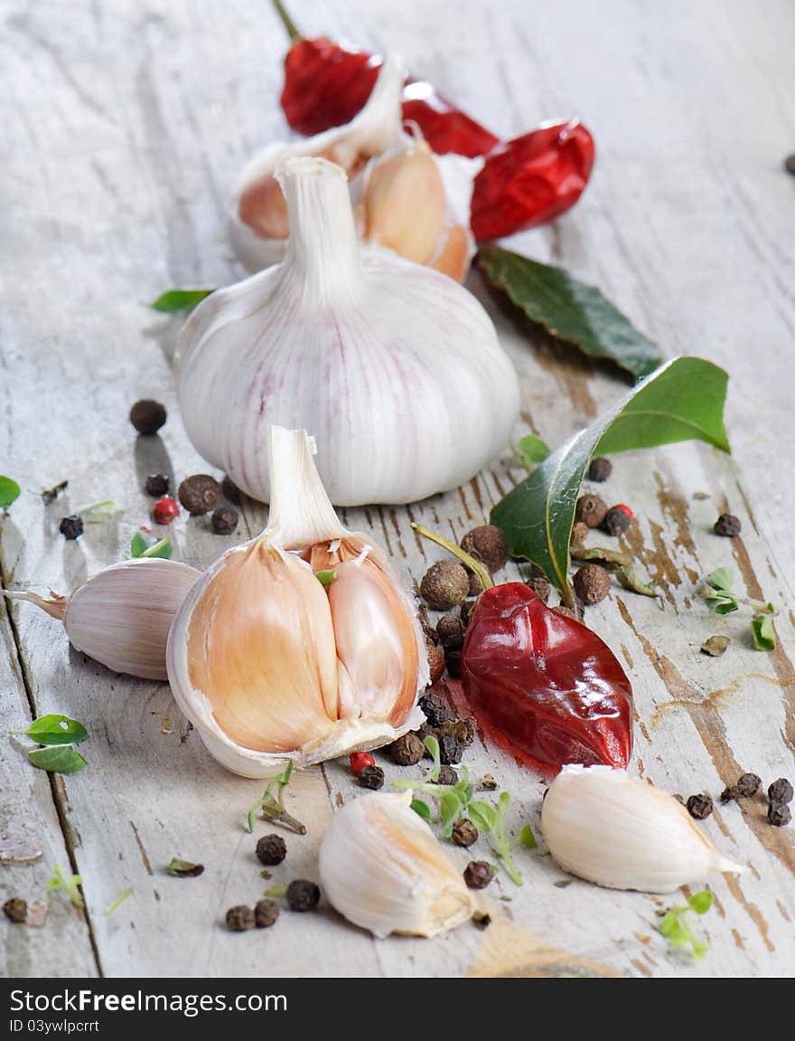 Garlic and peppers on a wooden table