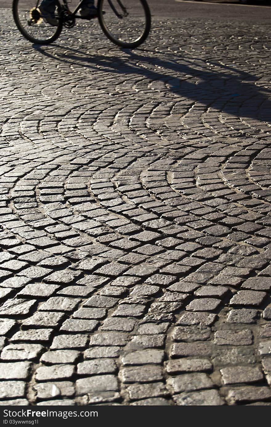 Squared old paving with passing bicycle