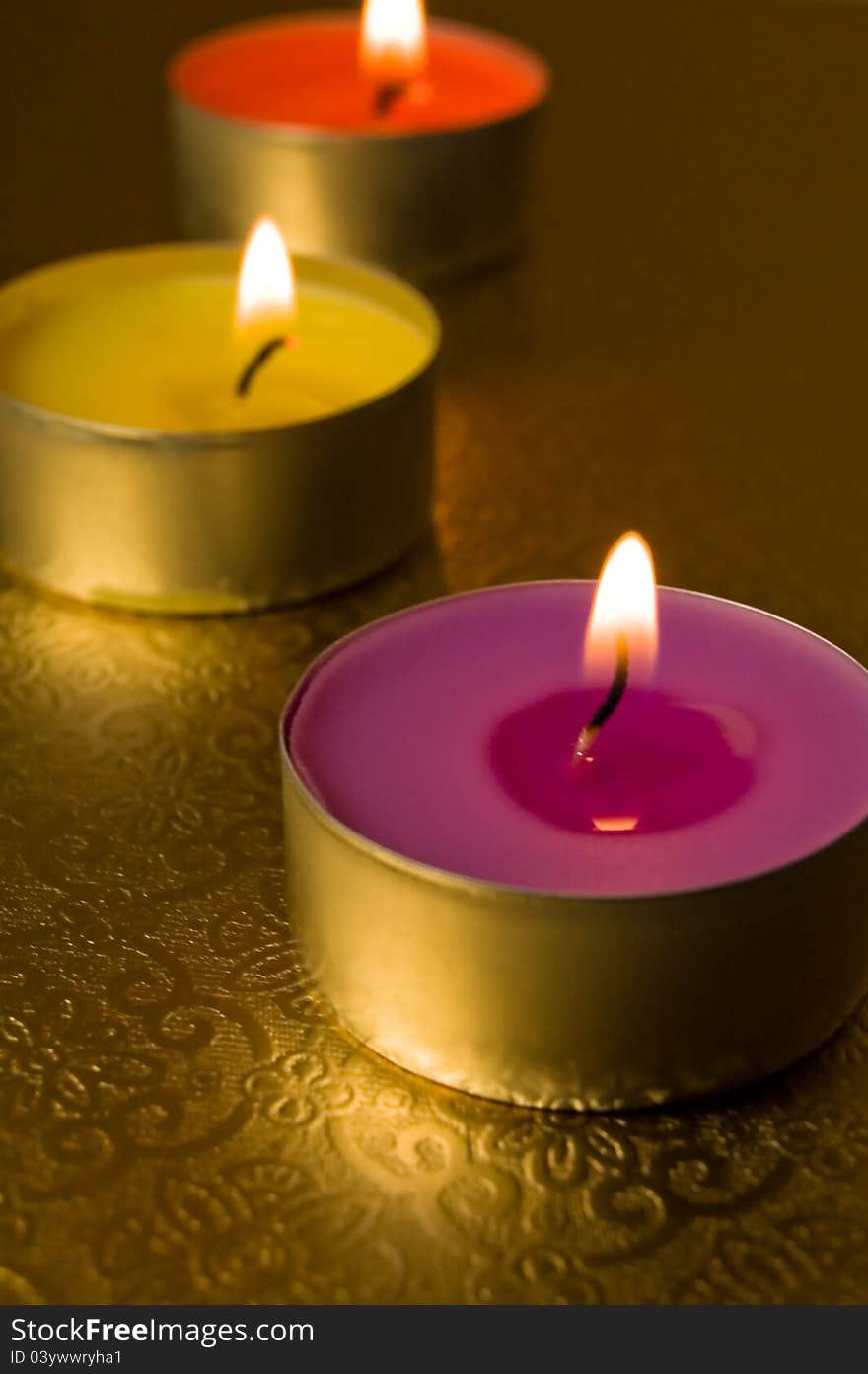 Three candles on a gold background