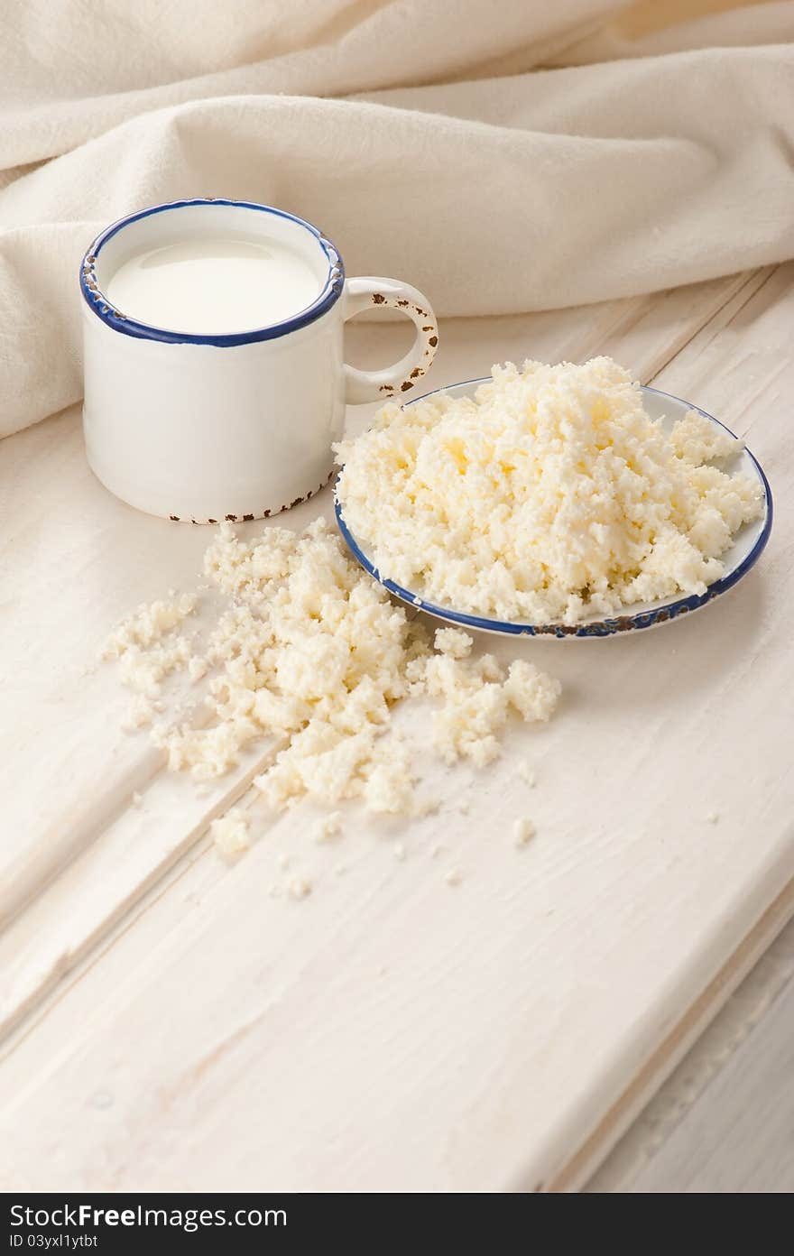 Breakfast with milk and cottage cheese on old wooden table with linen tablecloth. Breakfast with milk and cottage cheese on old wooden table with linen tablecloth