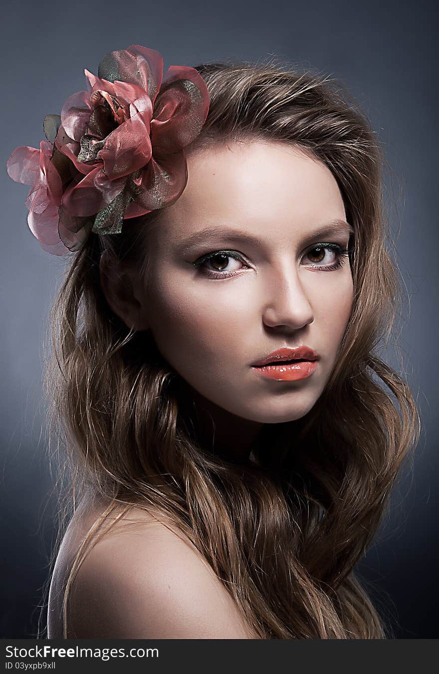 Portrait of young attractive girl with bow closeup