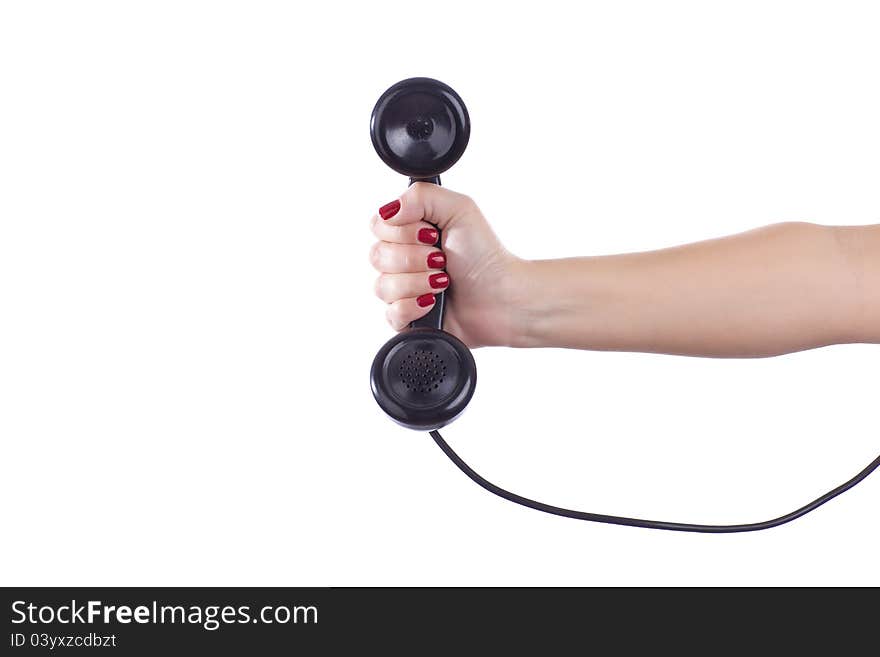 A female holds out a retro telephone handset. A female holds out a retro telephone handset