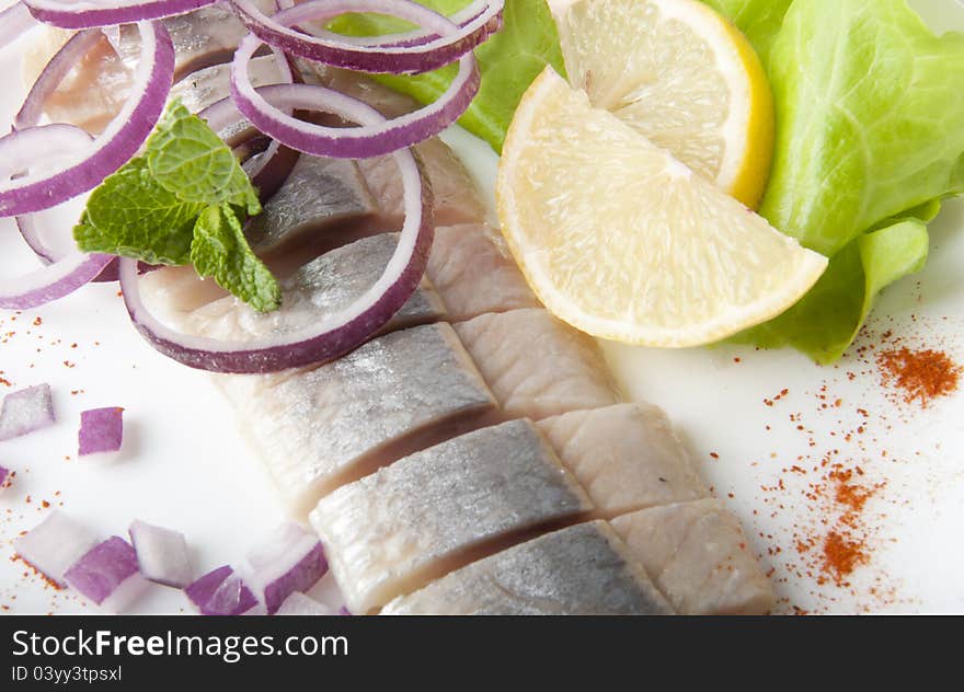 Portion of typical Dutch herring on the plate and on white Background. Portion of typical Dutch herring on the plate and on white Background