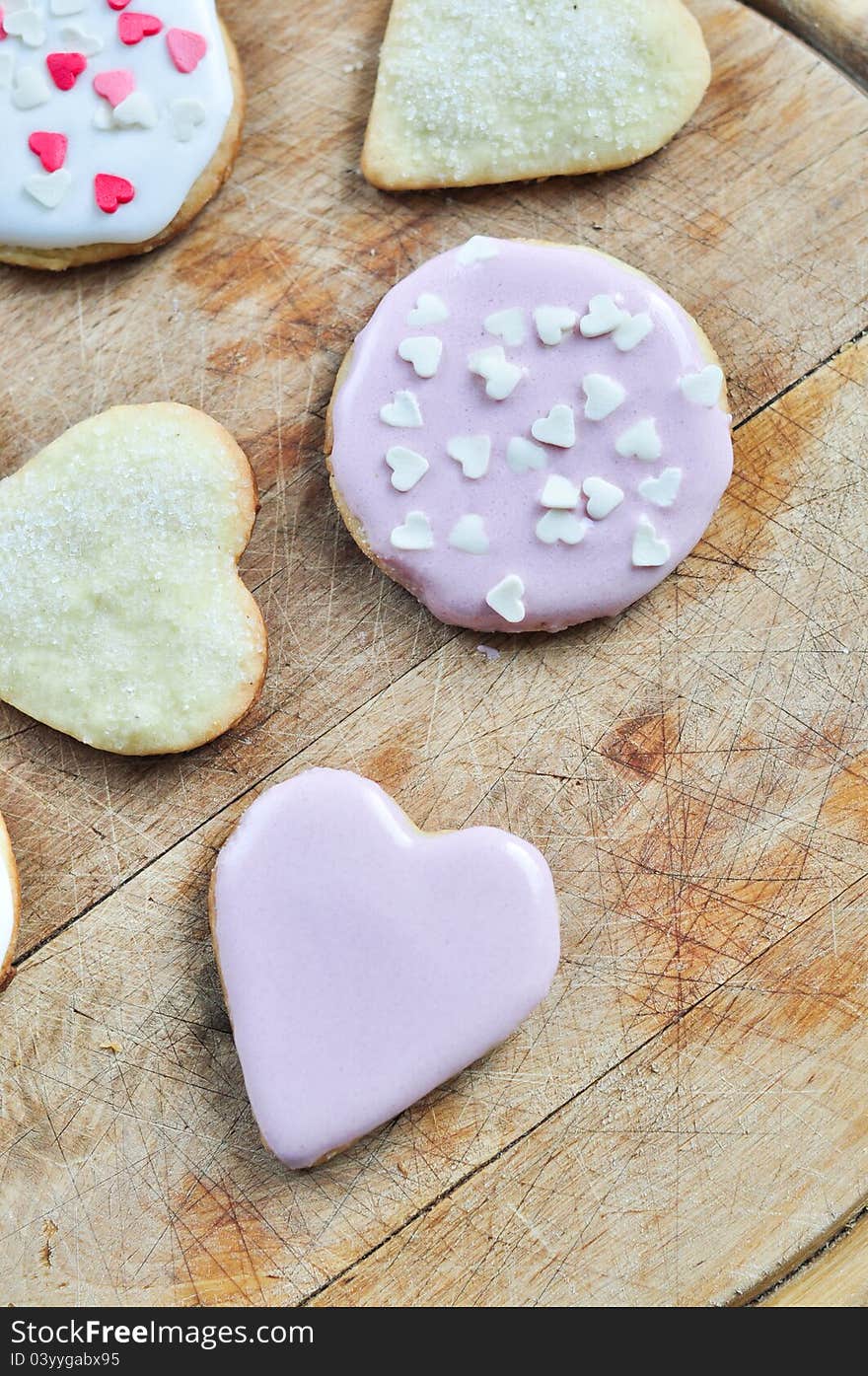 Heart-shaped biscuits on a wooden board.
