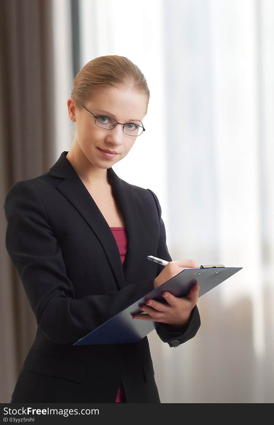 Beautiful young business woman with folder