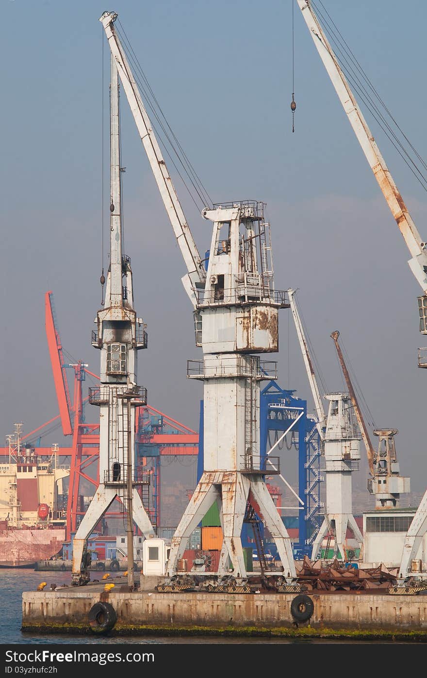 Cranes near the sea. They are used for lifting heavy cargos and containers from cargo vessels.