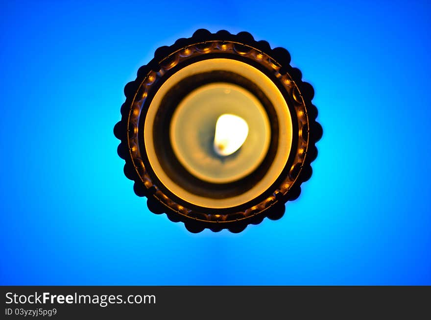 Top view of the candle on blue background.