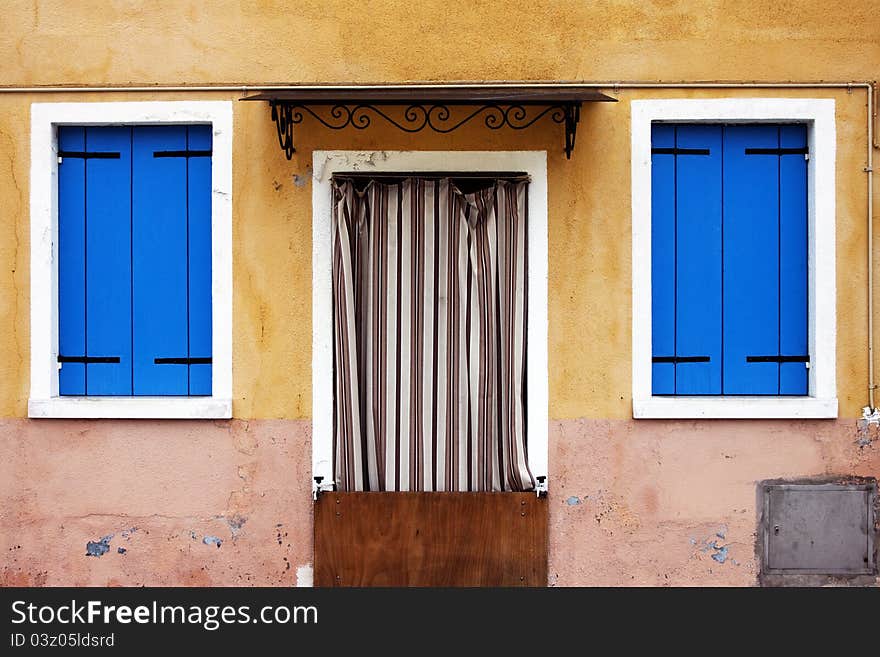 Burano island near Venice, colored windows