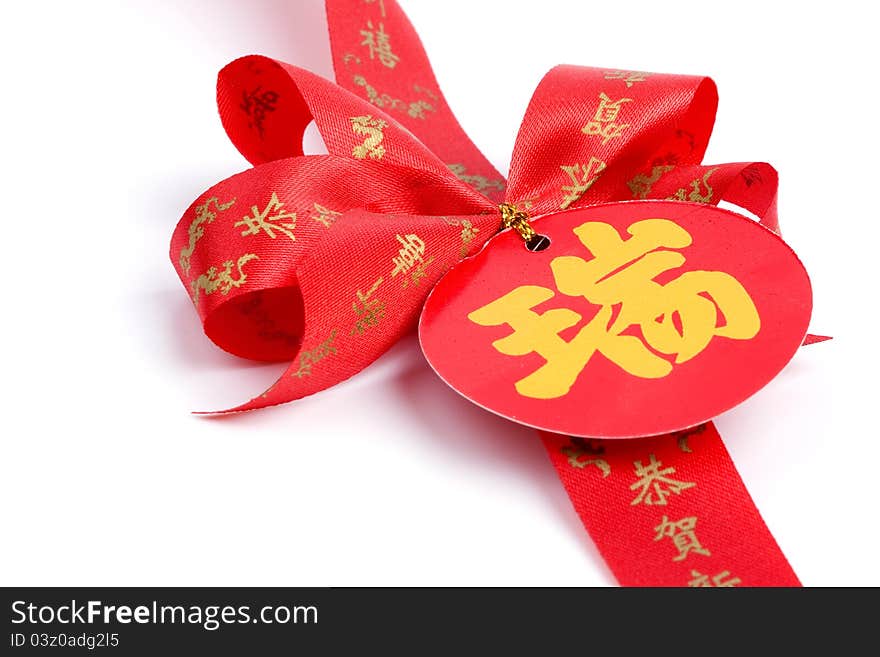 Red bow and Chinese alphabet on white background