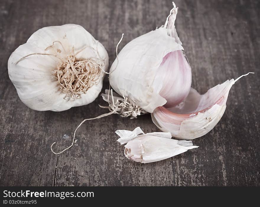 Close up image of garlic on rough chopping board