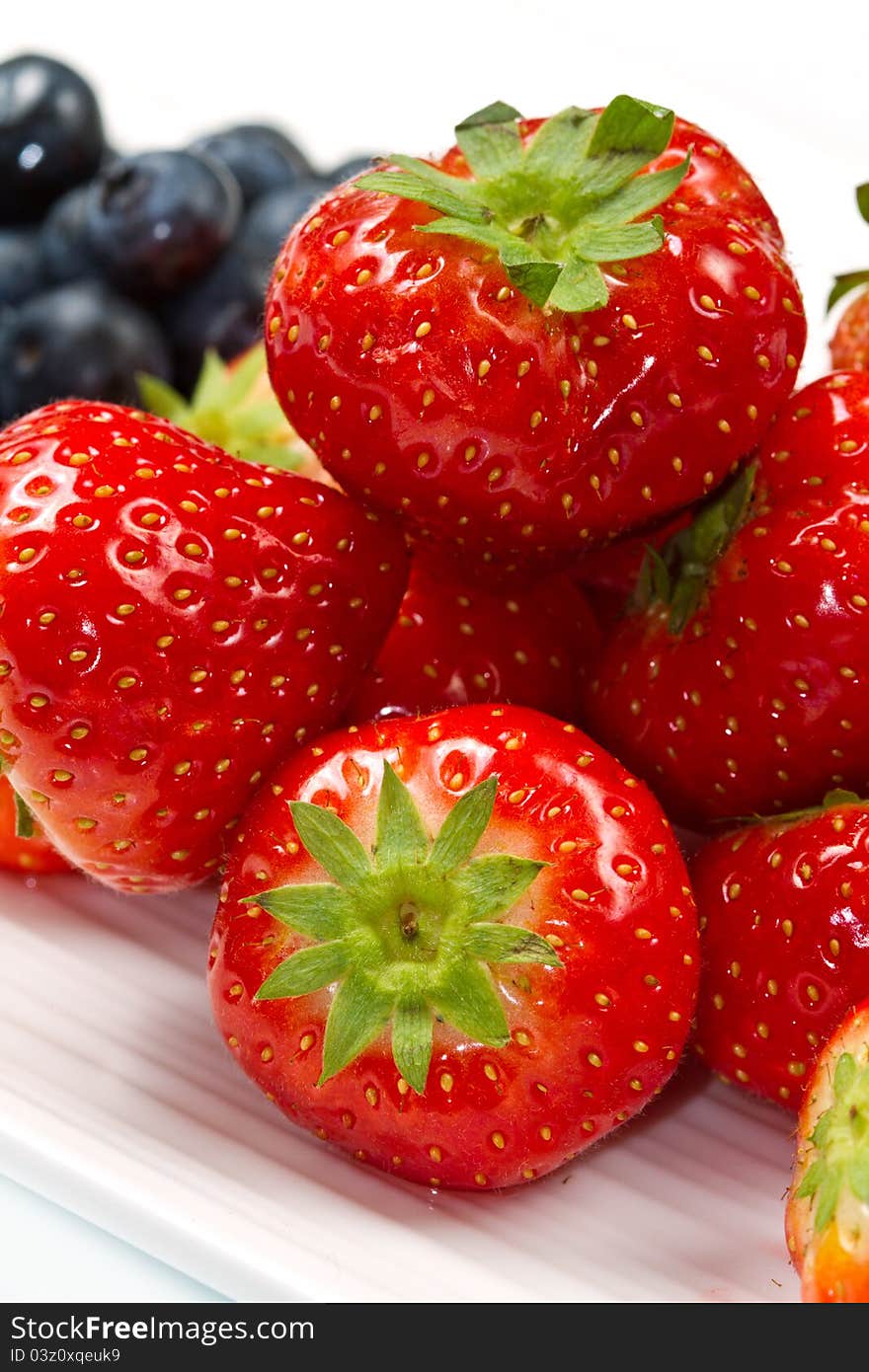 Fresh ripe strawberry on white dish