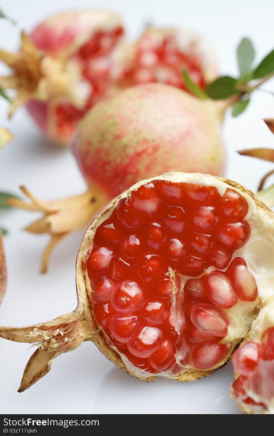 Forefront of a pomegranate pieces on a white