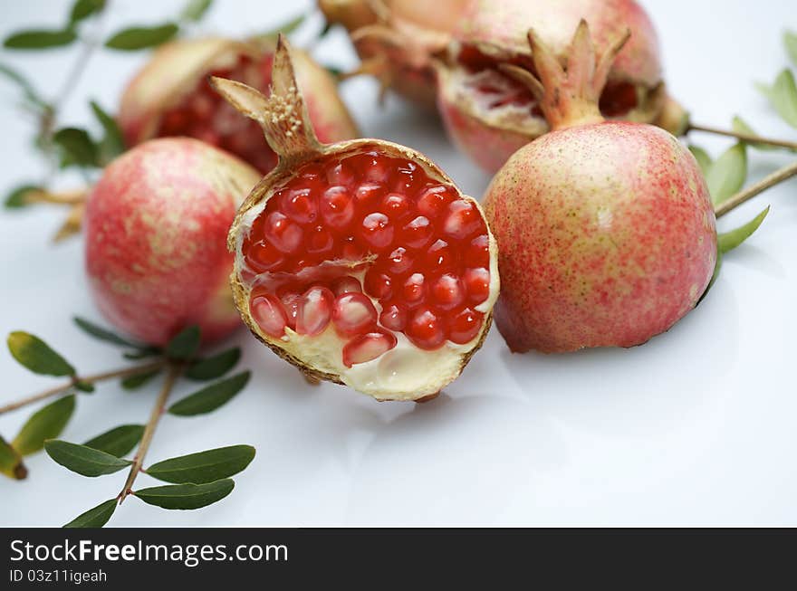 Forefront of a pomegranate pieces on a white