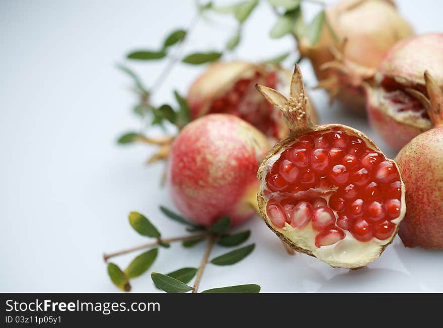 Forefront of a pomegranate pieces on a white