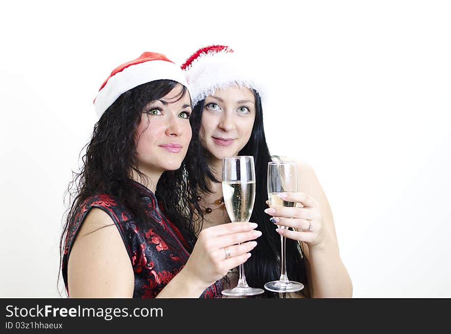 Christmas or new year party: two girls in red hats have fun