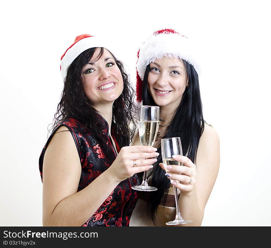 Christmas or new year party: two girls in red hats have fun