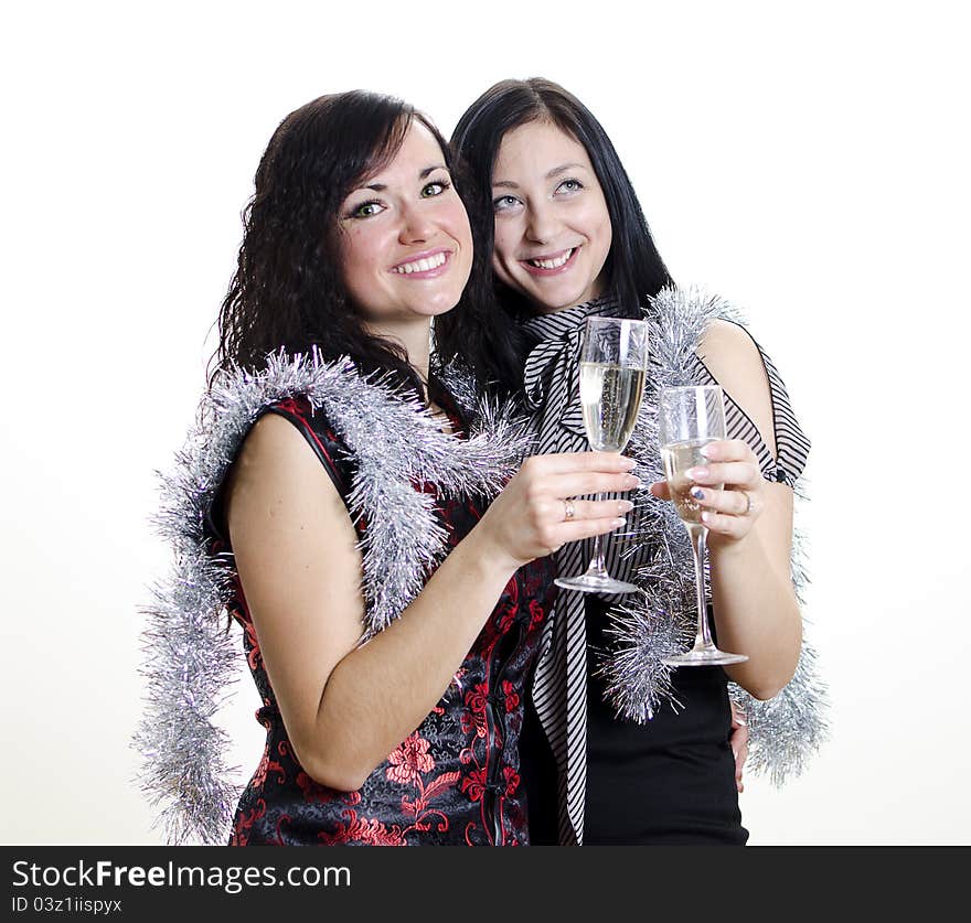 Christmas or new year: two girls congratulates with glasses of wine