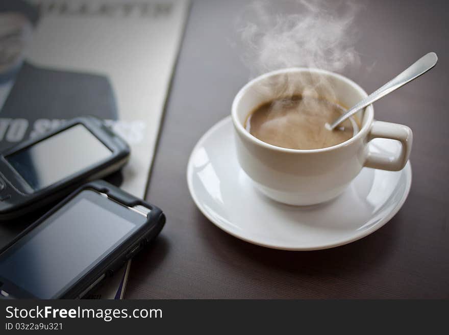 Drinking coffee on the desk.