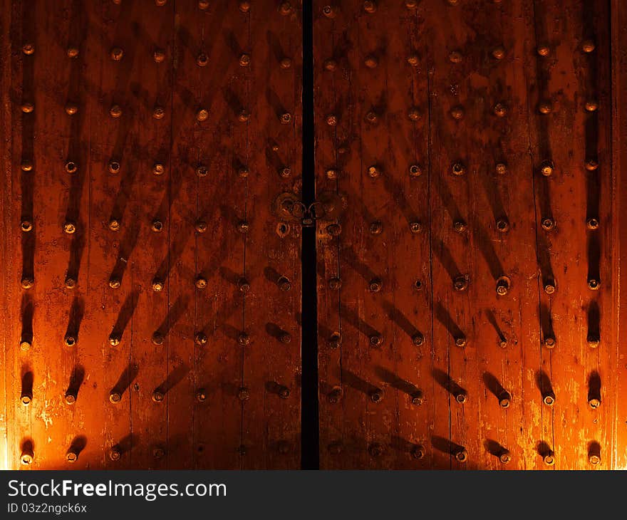 An ancient Chinese wooden door by night.