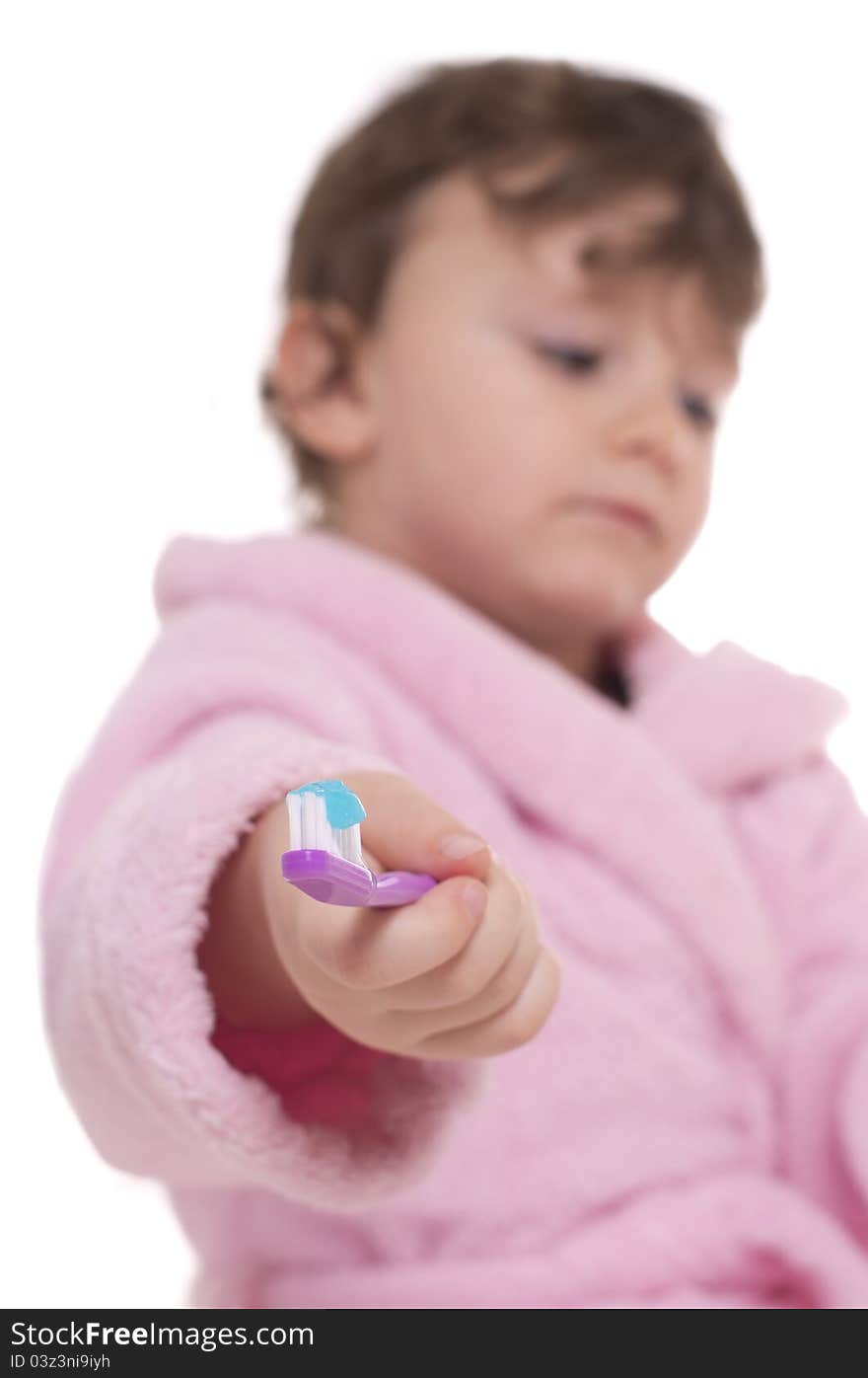 Three years old girl in pink dressing gown/bathrobe hesitating to brush her teeth. Three years old girl in pink dressing gown/bathrobe hesitating to brush her teeth.