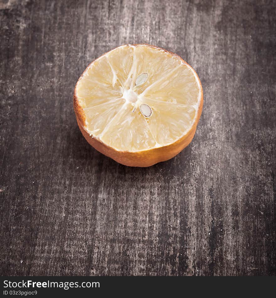 Dried lemon on old wooden plank