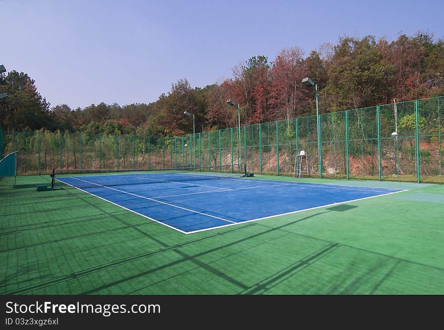 Empty tennis courts, net and lines, wideangle from center. Empty tennis courts, net and lines, wideangle from center