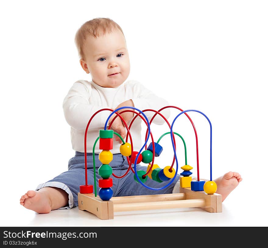 Cheerful baby girl with color educational toy. Cheerful baby girl with color educational toy