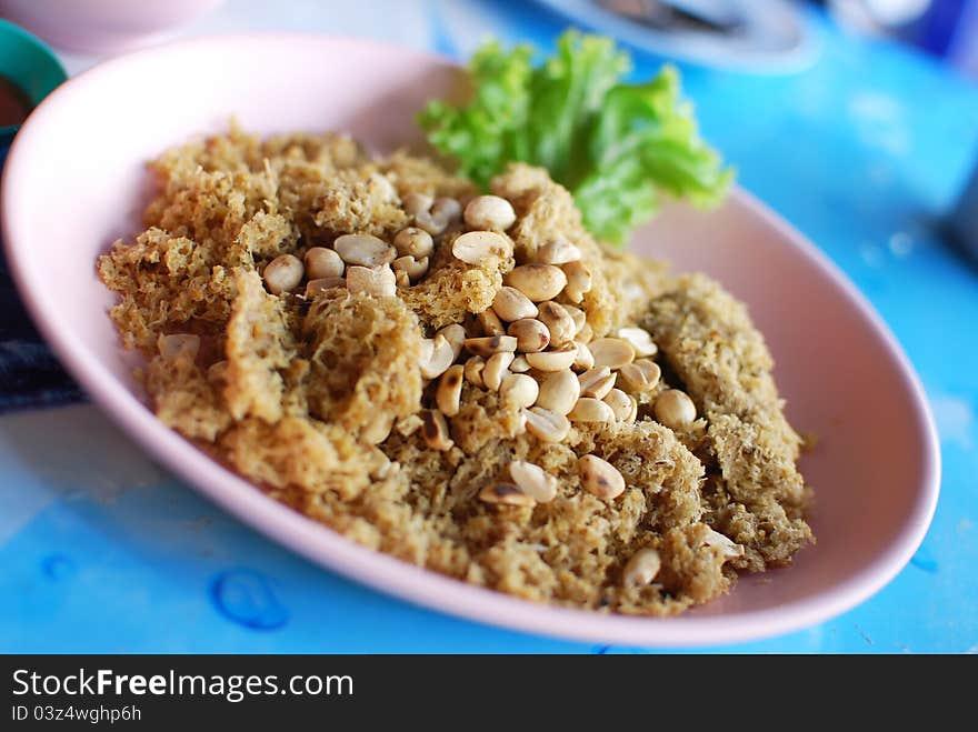 Spicy salad of fried minced fish , Asian style food in Thailand