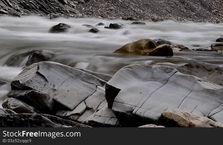 The large stones near the water