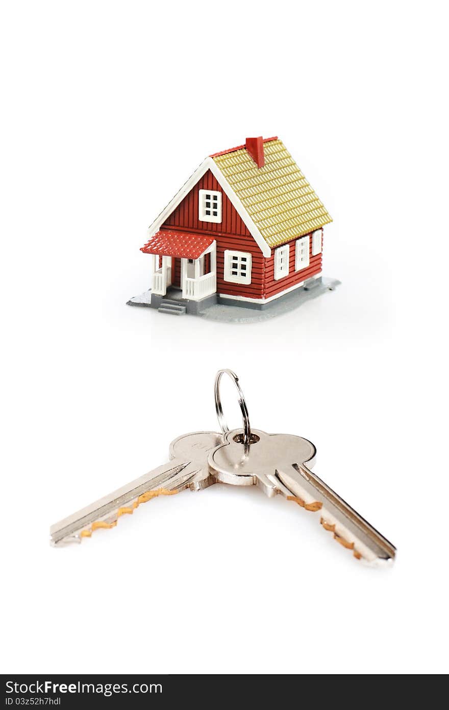 Keys and little house over white background. Keys and little house over white background.