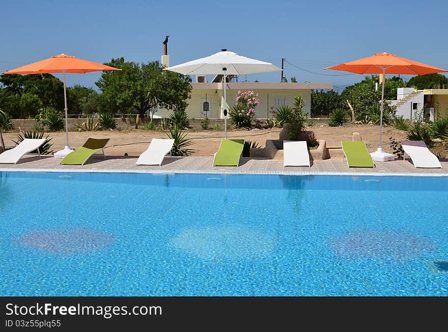 Swimming pool and sun loungers