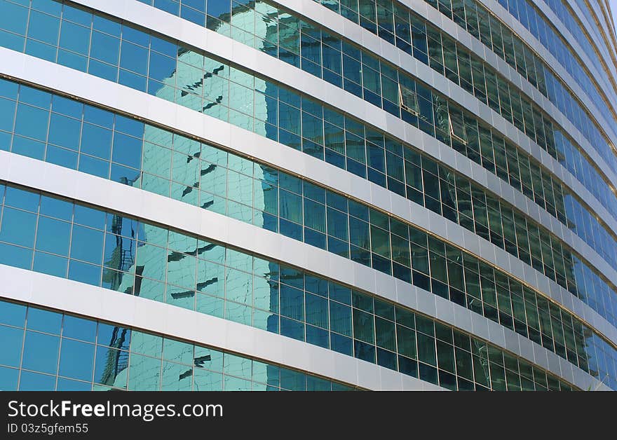 Reflections on office building blue glass wall. Reflections on office building blue glass wall